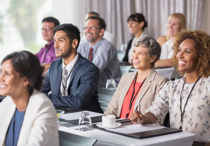 Diverse Group Of Smiling People At A Seminar