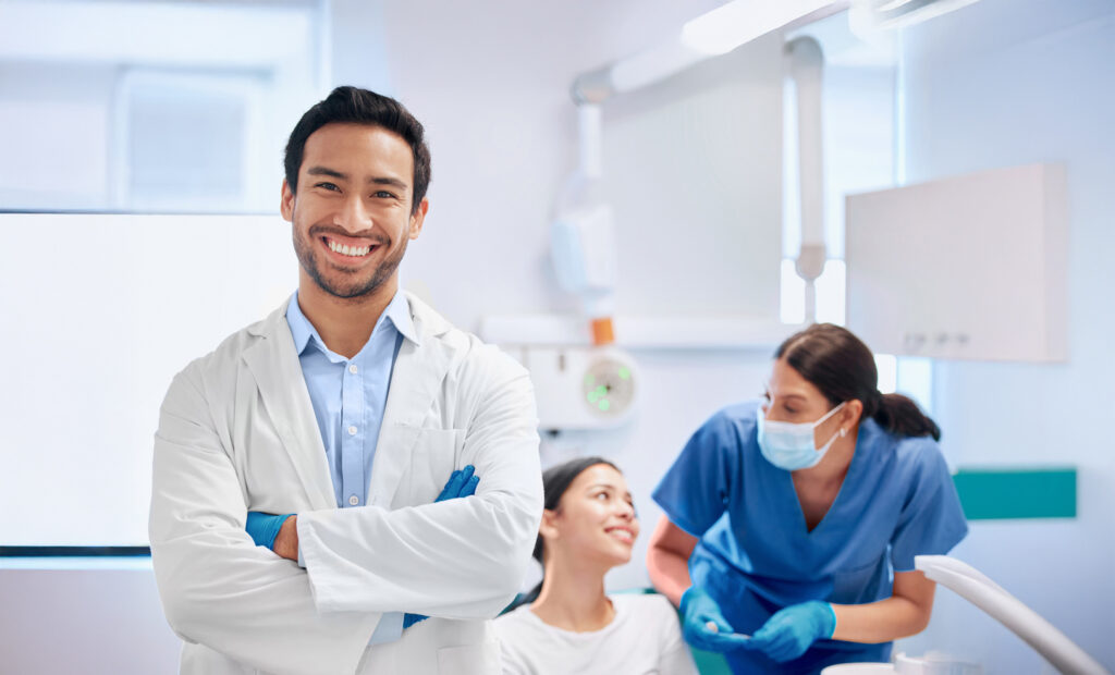 Shot Of A Young Handsome Dentist With His Arms Crossed