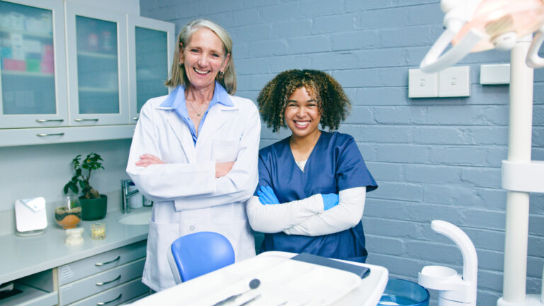Professional Dentists Smiling In A Modern Dental Office Environment