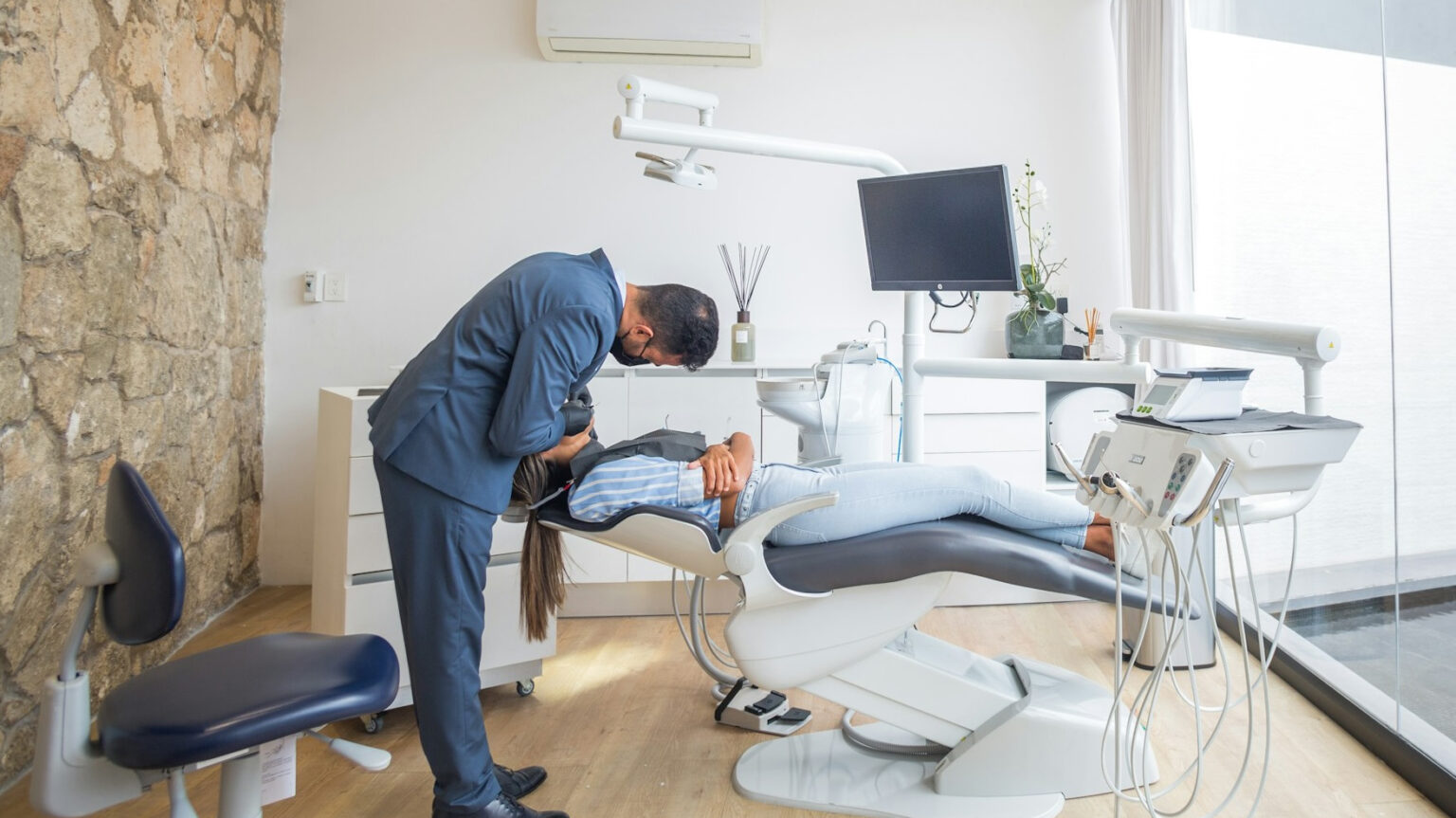 Dentist With Patient In Operating Chair