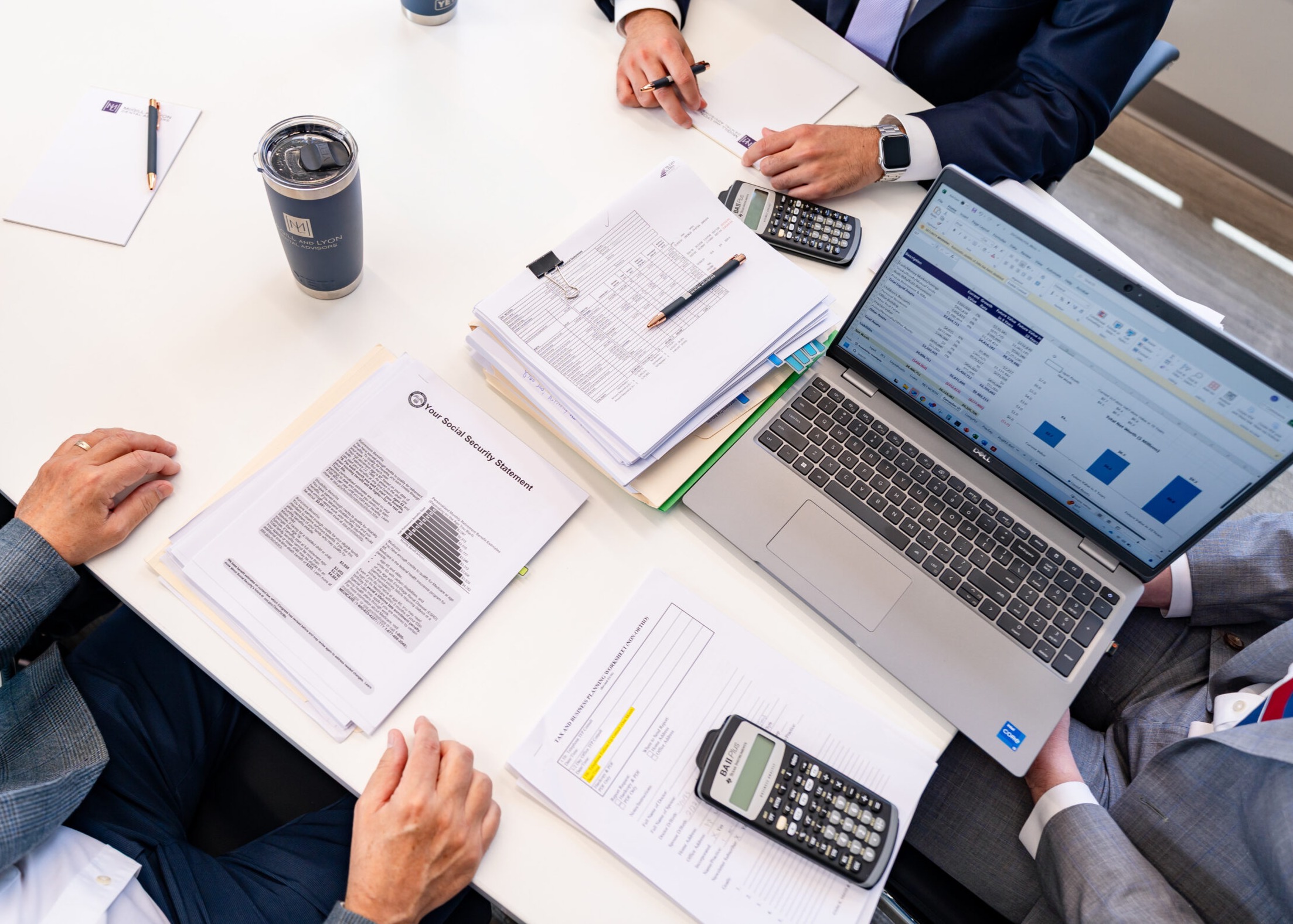 Man Looking At Charts And Graphs On Desk