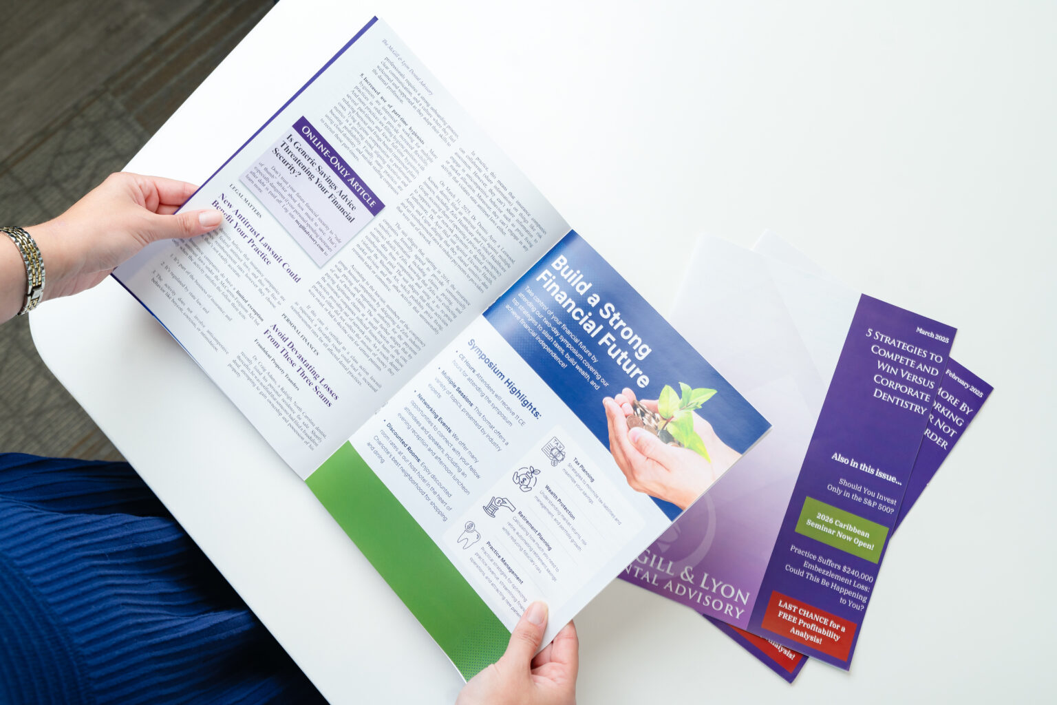 Person reads McGill and Lyon brochure booklet at white desk